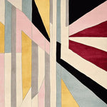 A contemporary Fractured Light Hand Tufted Area Rug featuring an abstract geometric pattern with vibrant colors like pink, yellow, black, and red. This wool rug is perfect for adding a modern touch to living rooms, making it an ideal choice for those seeking stylish area rugs for living room decor.