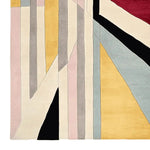 A close-up view of the Fractured Light Hand Tufted Area Rug showcasing its vibrant geometric pattern. This contemporary wool rug features a mix of colorful stripes and shapes, perfect for adding a modern touch to area rugs for the living room.