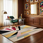 Colorful geometric rug in a room with wooden floor, desk, and wall art.