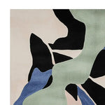 A close-up of a contemporary area rug featuring an abstract design with soft pastel colors, including green, blue, and black. This wool rug is perfect for adding a modern touch to living room spaces. Ideal as a living room rug sized 8x10, showcasing a flow of fragmented nature-inspired patterns.