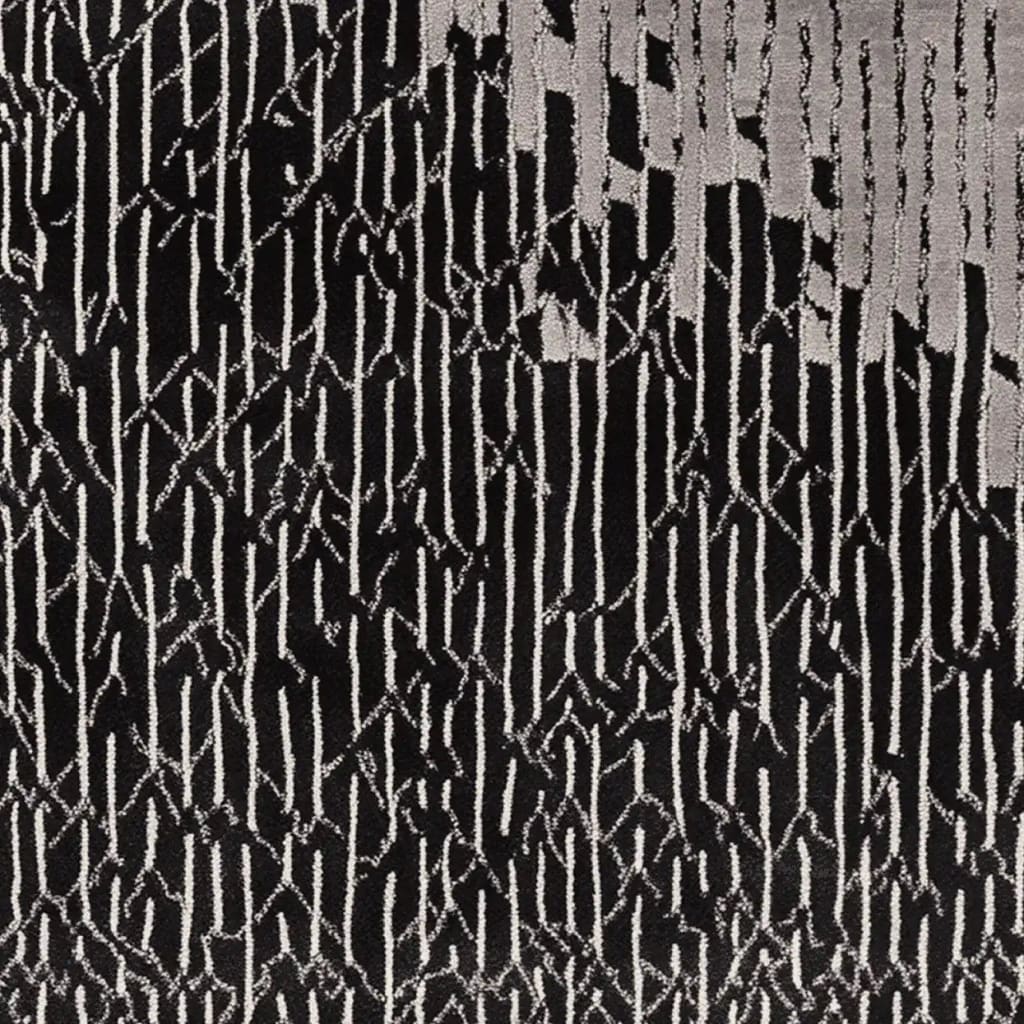 A contemporary hand tufted area rug featuring a bold black and white abstract pattern. This wool rug is perfect for adding a modern touch to living room spaces, making it an ideal choice for those seeking stylish living room area rugs.