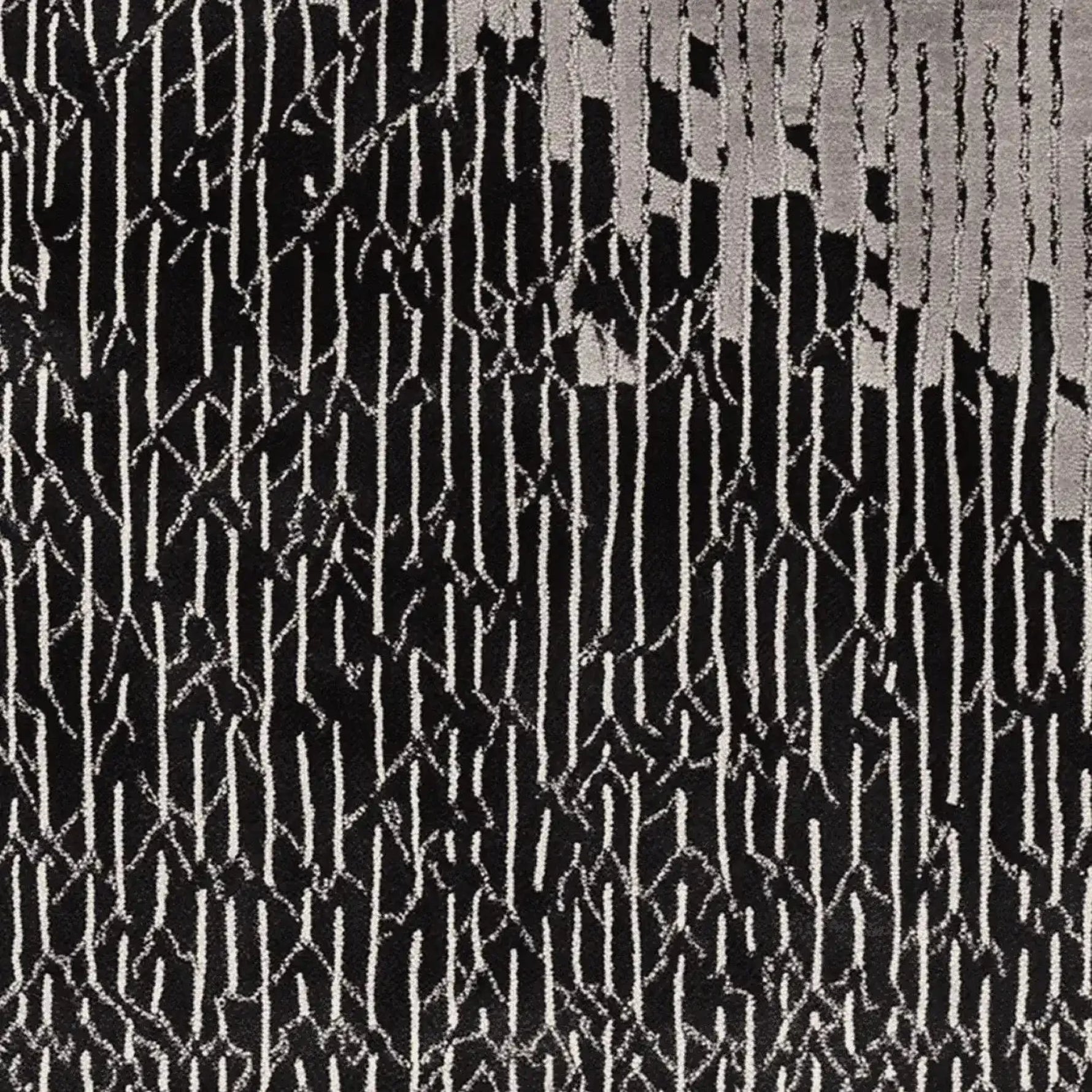 A contemporary hand tufted area rug featuring a bold black and white abstract pattern. This wool rug is perfect for adding a modern touch to living room spaces, making it an ideal choice for those seeking stylish living room area rugs.