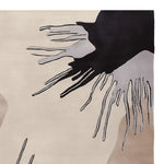 Close-up view of the Fringe Flow Hand Tufted Area Rug showcasing its contemporary abstract design with flowing black and gray patterns on a neutral beige background. Perfect as a wool rug for living room spaces, especially in 8x10 dimensions, this rug adds a modern touch to any living room area.