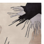 Close-up view of the Fringe Flow Hand Tufted Area Rug showcasing its contemporary abstract design with flowing black and gray patterns on a neutral beige background. Perfect as a wool rug for living room spaces, especially in 8x10 dimensions, this rug adds a modern touch to any living room area.