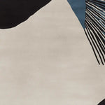 Close-up of a contemporary area rug showcasing an abstract design with bold black and blue lines on a neutral wool background, ideal for living room rugs 8x10.