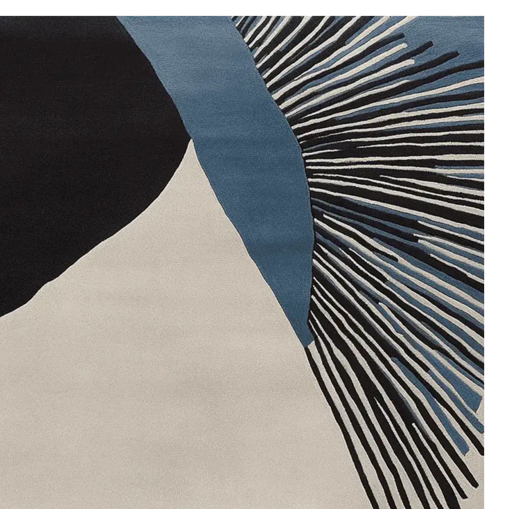 Close-up view of a contemporary area rug featuring an abstract design with black, blue, and cream tones. This hand-tufted wool rug is perfect for adding a modern touch to living room spaces, especially in an 8x10 size.