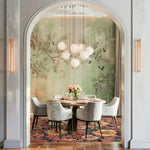 Elegant dining room featuring a vintage-inspired floral area rug beneath a round dining table with plush chairs. The wool rug, with its vibrant floral patterns, adds a touch of warmth and style, making it perfect for both dining room and living room spaces.