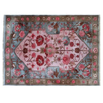 An enchanting area rug featuring a vibrant floral design with rich pink and red flowers on a soft pink and blue background. Ideal for adding a touch of elegance to living room area rugs.