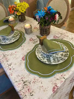 Garden Grove placemats angled dining table, olive scalloped ovals with blue border, botanical china, green napkins, floral cloth