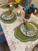 Garden Grove placemats overview on table, two olive green scalloped ovals with blue trim, botanical china, colorful flowers