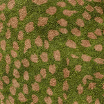 Close-up view of the Garden of Courage hand-tufted area rug, featuring a vibrant abstract pattern with green and brown tones. This vintage rug is crafted from wool, ideal for adding a touch of elegance to dining rooms or bedrooms. Perfect as a bedroom rug or dining room carpet.