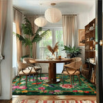 A vibrant living room featuring a 'Garden of Eden' hand-tufted wool rug with an intricate floral design. This large area rug, perfect for an office or living room, adds a splash of color beneath a round dining table and chairs. The lush greenery and natural light complement the rug's rich patterns, making it an ideal square area rug choice for any stylish space.