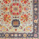 A beautifully detailed hand-knotted area rug featuring intricate floral patterns in vibrant colors. The Persian-style design showcases large, colorful blooms and classic motifs, perfect for enhancing any large living room space with elegance and charm.