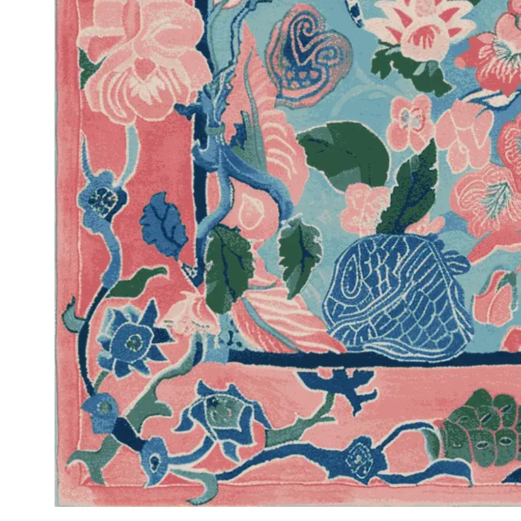 Close-up view of the Garden of Legends Hand Tufted Rug, showcasing a vibrant floral design in pink, blue, and green hues. This wool square area rug is perfect for adding a touch of elegance to any living room, making it a standout piece among large living room rugs.