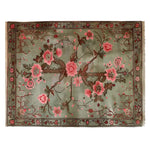 Top view of the Garden of Serein Knotted Wool Rug featuring a lush floral design with pink and brown flowers on a soft green background. Perfect area rug for living room settings, showcasing the elegance of wool rugs.