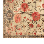 A beautifully detailed area rug featuring a vibrant floral design with large red and pink flowers and intricate branches on a soft beige background. Perfect for adding elegance to large living room spaces, this knotted wool rug combines style and comfort, making it an ideal choice for rugs for the living room.