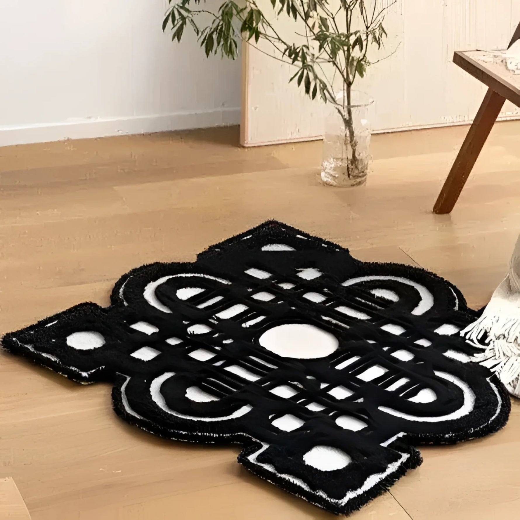 A stylish and contemporary Garden of the Night Tufted Area Rug, featuring a bold black and white geometric pattern, elegantly placed in a modern living room setting. Ideal for those seeking unique living room area rugs to enhance their space, particularly in an 8x10 size.