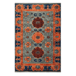 The Garden of Tradition Hand Tufted Rug features a stunning floral design with vibrant orange and deep blue flowers on a grey background. Perfect as a large area rug for living rooms or offices, this wool rug combines elegance with functionality, making it an ideal choice for anyone looking to add a touch of luxury to their space.