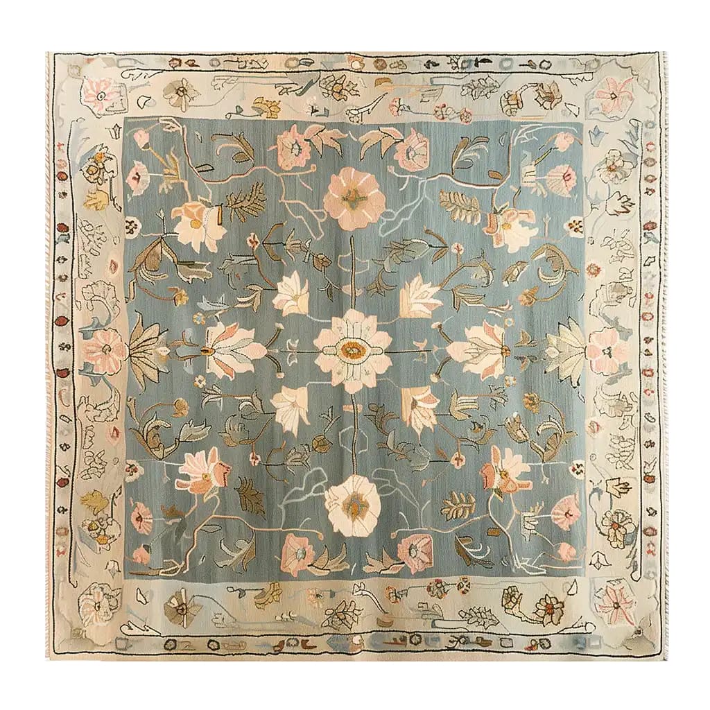 A beautifully designed area rug with an intricate floral pattern, the Garden Serenity Knotted Wool Rug showcases delicate pink and beige blooms against a soothing blue background. Ideal for enhancing living room spaces, this wool rug adds a touch of elegance and serenity to any home decor.