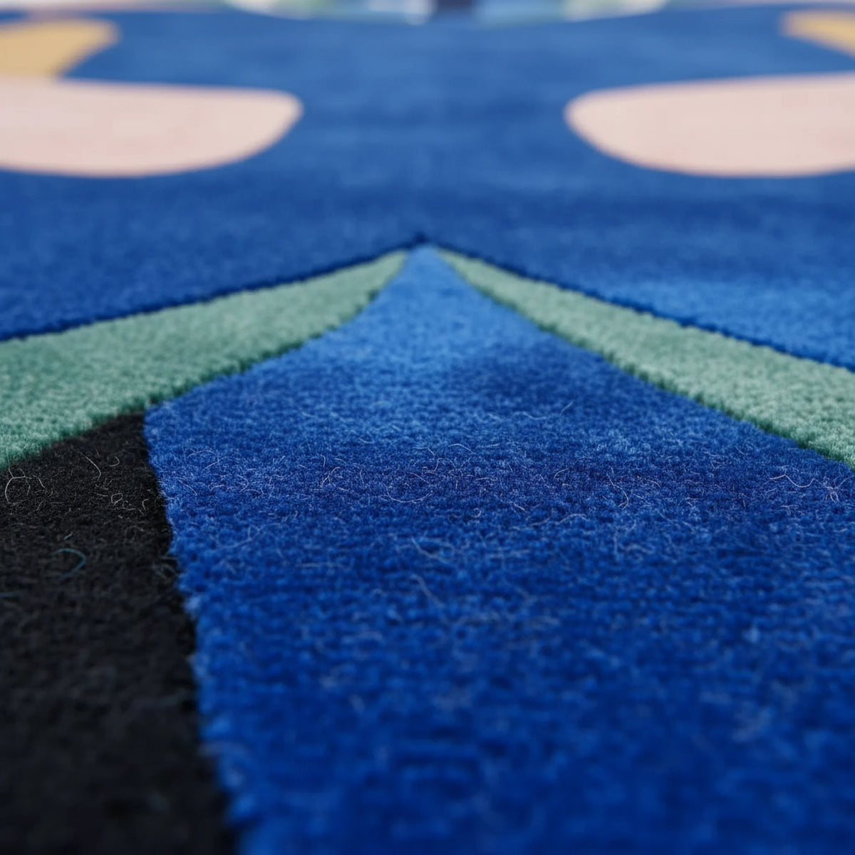 Close-up of a textured blue rug with geometric patterns