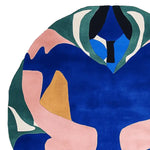 Top view of a contemporary area rug featuring an abstract design with bold colors like blue, green, pink, and mustard, ideal for adding a modern touch to living rooms. This wool rug is perfect for those seeking unique rugs for living room spaces, available in versatile sizes like 8x10 and round shapes.