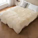 Cozy and luxurious genuine sheepskin wool area rug draped over a bed in a stylish bedroom setting. This versatile area rug adds warmth and elegance, perfect for living room area rugs.