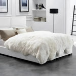 Luxurious Genuine Sheepskin Wool Area Rug draped elegantly over a modern bed in a stylish living room. Perfect for adding warmth and comfort to any living space, this area rug showcases soft, fluffy textures ideal for living room area rugs.