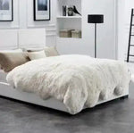Luxurious Genuine Sheepskin Wool Rug draped elegantly over a modern bed in a stylish, minimalist bedroom setting. Ideal for those seeking plush area rugs for living room spaces, this living room area rug adds warmth and sophistication to any decor.