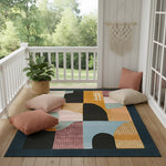 Geo Terra abstract rug with arches and color blocks on a porch with floor cushions