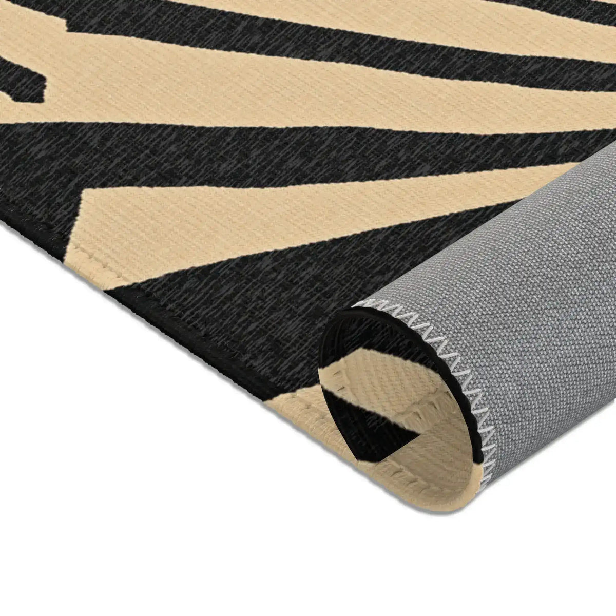 Close macro of beige puzzle-cut non-slip felt underside corner of Geometric Sunburst Accent Rug
