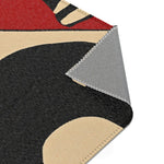 Corner turned back on Geometric Sunburst Accent Rug showing charcoal and cream sunburst face and grey backing with stitching