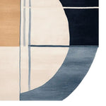 Close-up of a contemporary area rug featuring an abstract geometric design in shades of blue, beige, and cream. This wool rug is perfect for large living rooms, adding a touch of modern elegance to any space. Ideal for those seeking stylish rugs for living room decor.