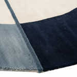 Close-up of a blue and gray checkered rug with a white background