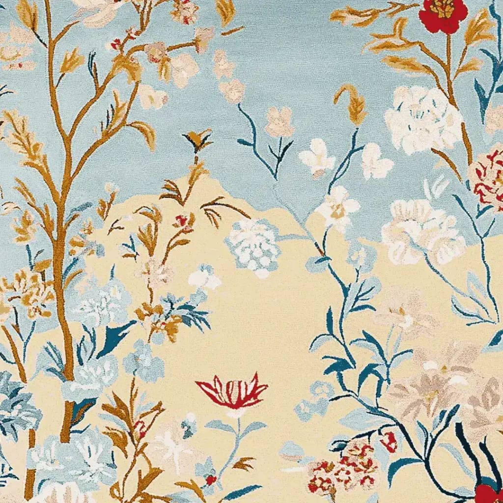 A beautifully designed area rug featuring a hand-tufted wool pattern with vibrant floral motifs in shades of blue, red, and beige. Ideal for large living rooms, this elegant wool rug adds a touch of nature-inspired art to any space.