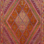 The Gilded Citrus Diamonds Hand Knotted Area Rug showcases a vibrant geometric pattern with intricate diamond shapes in warm hues of orange, pink, and gold. Perfect for adding a splash of color to your space, this rug is ideal for those seeking rugs for living room settings or an 8x10 living room rug to enhance their home decor.