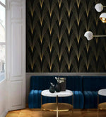Gilded Grandeur Art Deco wallpaper in bar setting; gold fan lines on black, navy tufted banquette, marble café table