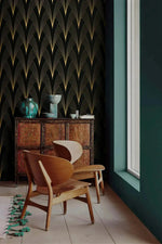 Gilded Grandeur wallpaper in moody corner; gold fan arches on black, wooden lounge chair, antique cabinet with teal vase