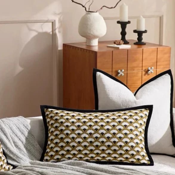 Stylish throw pillow with a gold and black fan pattern, perfect for enhancing home decor.
