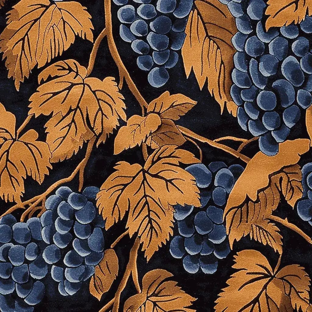 A detailed view of the Gilded Grapes Hand Tufted Area Rug, showcasing a vintage design with rich golden leaves and deep blue grapes. This wool rug is perfect for adding a touch of elegance to any living room, especially in an 8x10 size. The intricate pattern offers a luxurious feel, ideal for those seeking large living room rugs with a classic, timeless appeal.