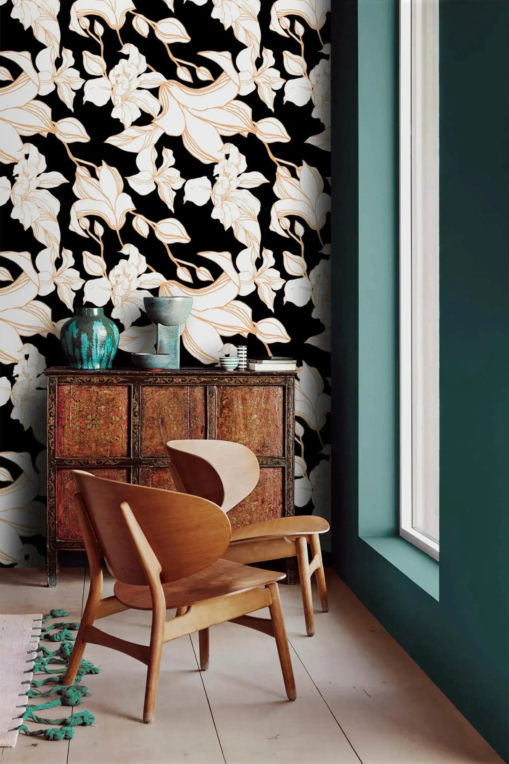 Gilded Petal wallpaper styled with antique sideboard, teal vase, and sculptural wood chair; white floral on black