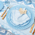 pale blue gingham scalloped-edge placemat styled with lattice charger and bamboo cutlery at table setting