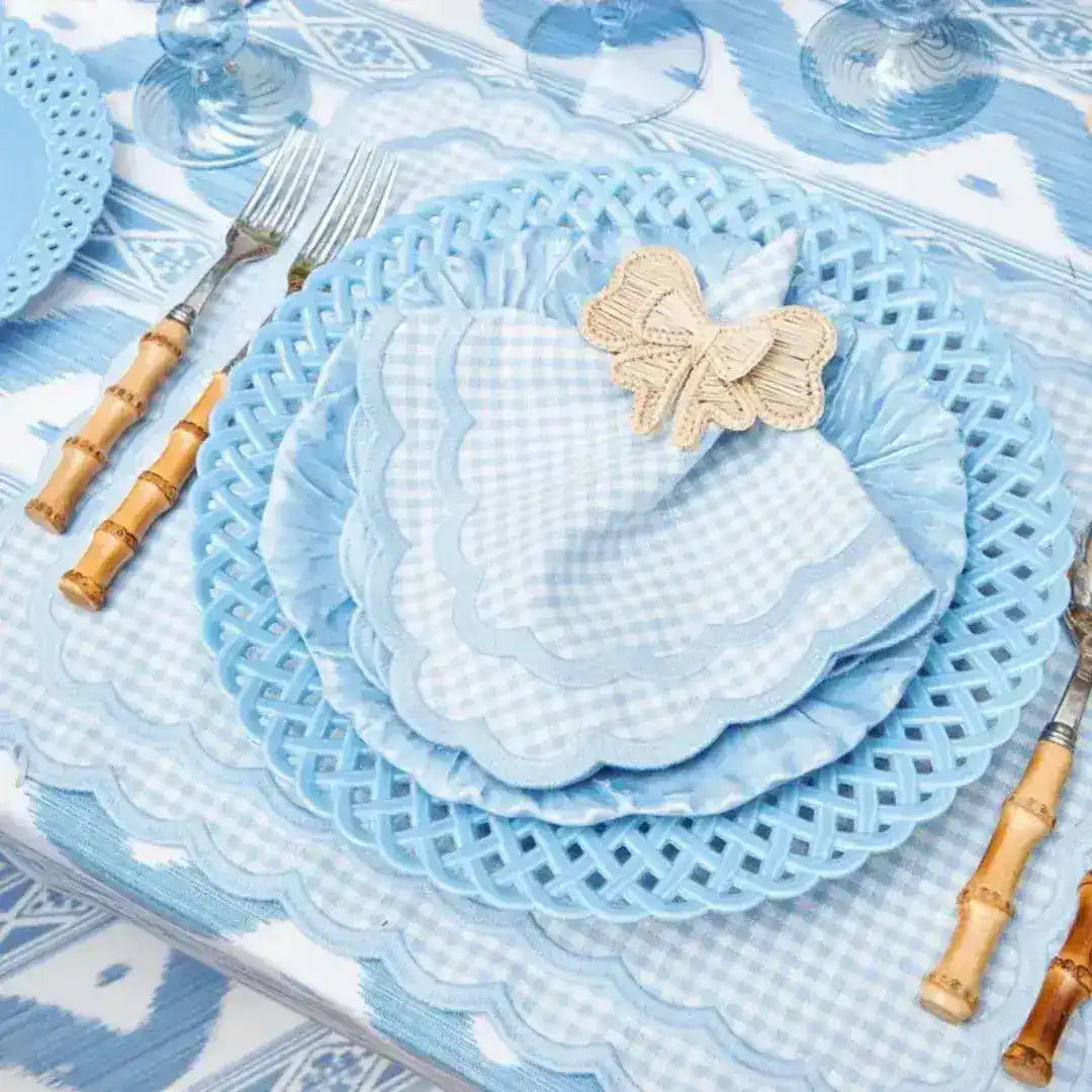 pale blue gingham scalloped-edge placemat styled with lattice charger and bamboo cutlery at table setting