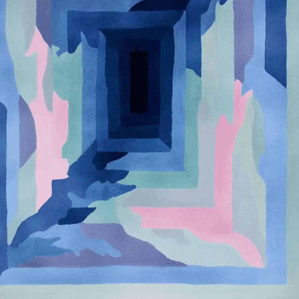 Top view of the Glacier Pulse Frame Hand Tufted Area Rug showcasing a captivating abstract design with layers of blue, pink, and green hues. This contemporary wool rug is perfect as a large living room rug, enhancing any space with its unique geometric pattern.