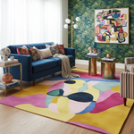 Modern living room with a blue sofa, colorful dog rug, and abstract art on the wall.