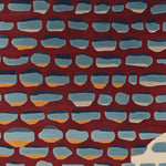 A vibrant area rug featuring a contemporary design with abstract blue and orange shapes on a rich red background. This hand-tufted wool rug is perfect for adding a splash of color to living room spaces, especially in an 8x10 size. Ideal for those seeking unique and stylish rugs for living rooms.