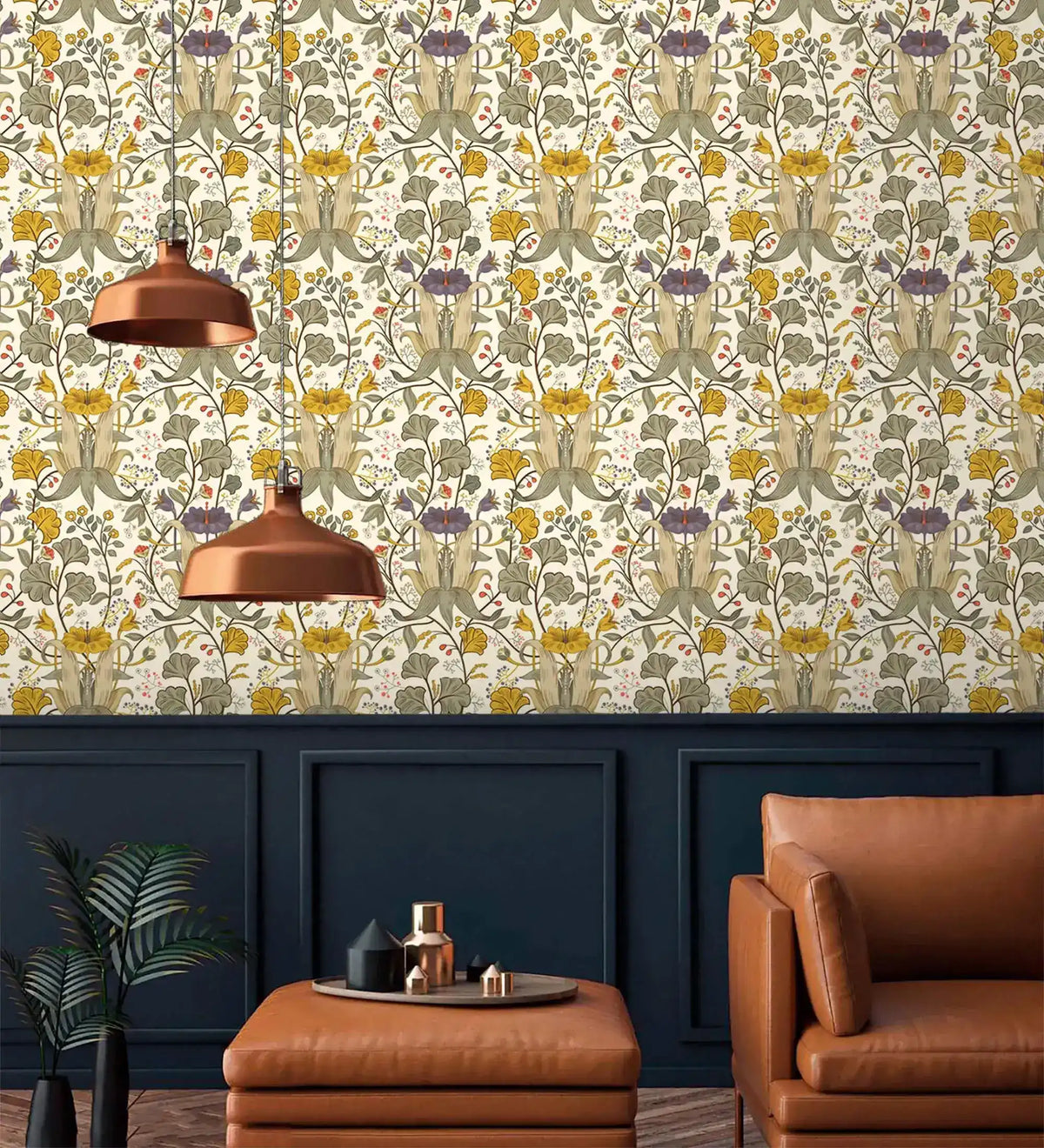 Vintage golden blooms wallpaper above dark navy wainscoting with copper pendant lights and tan leather armchair
