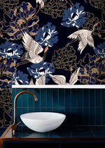 Golden crane flight wallpaper in a bathroom, white cranes and blue peonies on navy above teal tile