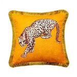 Golden fringe leopard throw pillow cover featuring a playful leopard design on a vibrant orange background.