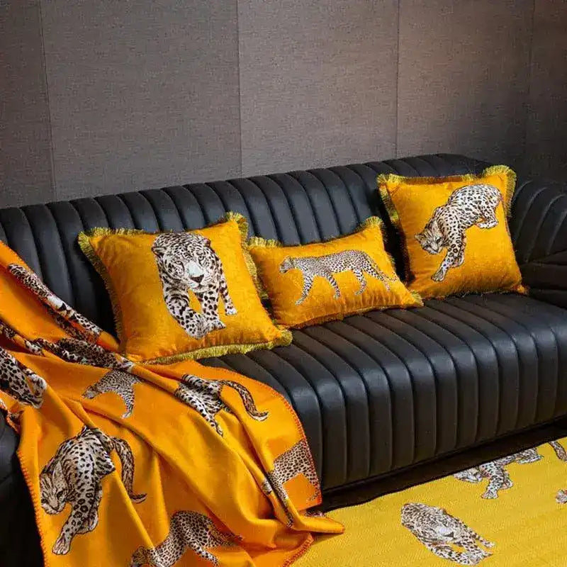 Golden fringe leopard throw pillow cover displayed on a stylish black sofa, adding a vibrant touch to home decor.