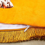 Close-up view of a golden fringe leopard throw pillow cover showcasing vibrant orange fabric and a hidden zipper detail.